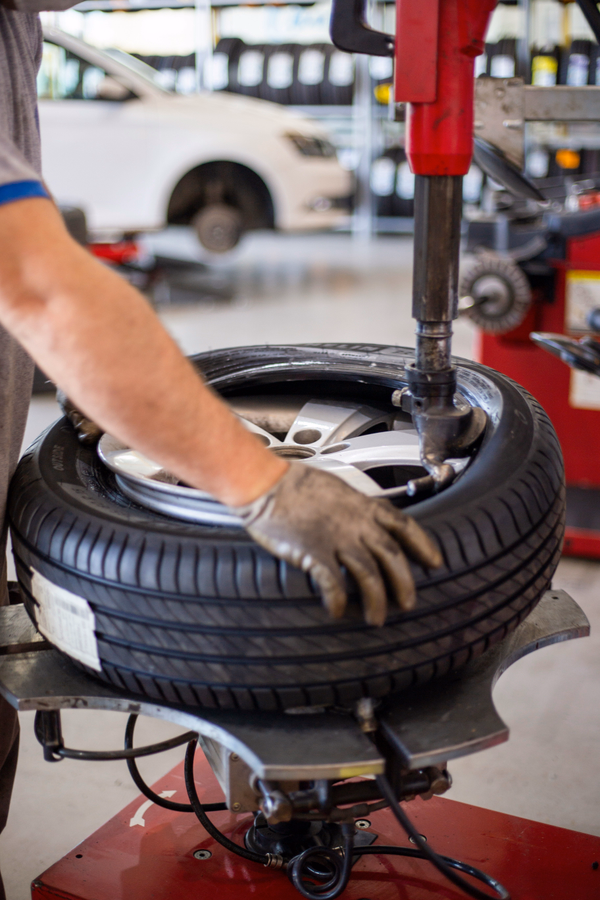 image of tires being placed on wheels